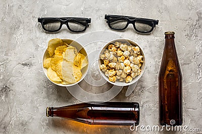 Film whatching party with beer, chips and pop corn stone background top view Stock Photo