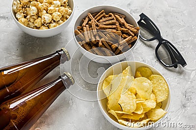 Film whatching party with beer, crumbs, chips and pop corn stone background Stock Photo