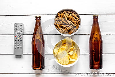 Film whatching party with beer, crumbs, chips white wooden background top view Stock Photo