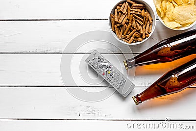 Film whatching party with beer, crumbs, chips white wooden background top view mockup Stock Photo