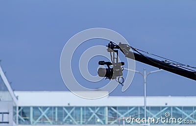 A filming camera holding by a crane Stock Photo