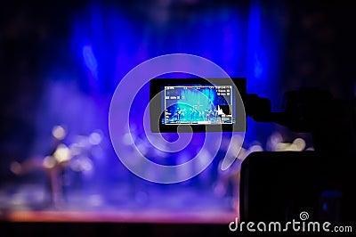 Filming the show from the auditorium. LCD viewfinder on the camcorder. Theatrical performance. The actors on stage Editorial Stock Photo