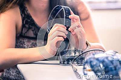 Cinema film reel on a cutting table: Filmmaker is working with vintage film strip Stock Photo