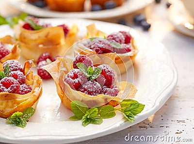 Filo cups with Mascarpone filling topped with raspberries , delicious dessert Stock Photo
