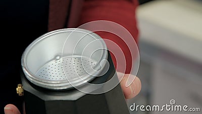 Filter from geyser coffee maker in women hands. Closeup shot Stock Photo