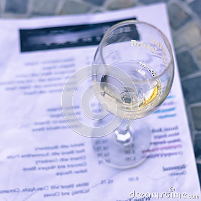 Filtered image wine taste concept with glass of dry white wine and tasting menu Stock Photo
