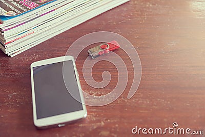 Filters vintage smartphone and book on a wooden table Stock Photo