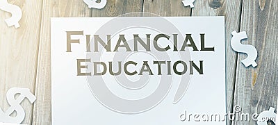 finacial education words on page and paper signs of dollar around. Business school concept Stock Photo