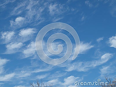 Whispy Clouds Powder Puffs on a Blue Sky Stock Photo