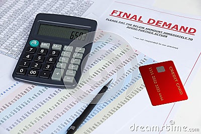 Final demand letter on a desk with a credit card and a calculator Stock Photo