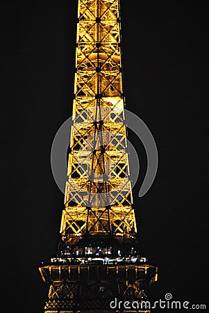 Final stretch of the Eiffel Tower illuminated at night Editorial Stock Photo