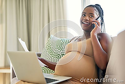 Finalising things before the baby arrives. a young mother to be working from home using her smartphone. Stock Photo