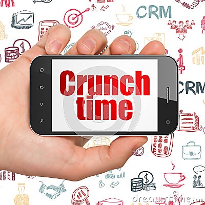 Finance concept: Hand Holding Smartphone with Crunch Time on display Stock Photo