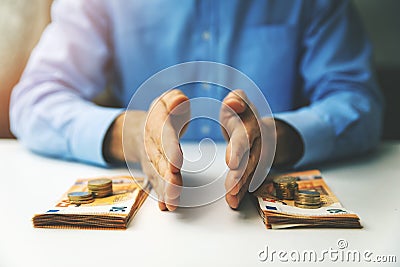 Finance management and budget planning concept - businessman splitting the money on the table Stock Photo