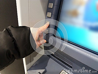 Finance, money, bank and people concept - close up of hands choosing option on atm machine Stock Photo