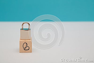 Finance security. Money safety. GDPR. Savings under guard. Encryption safeguard. Wooden cube, lock on top, coins sign Stock Photo