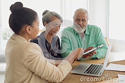 Financial adviser discussing information with a couple Stock Photo