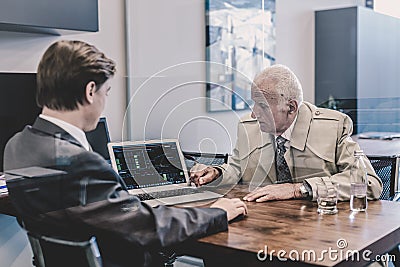 Financial advisor consulting senior client with his investment strategy. Stock Photo