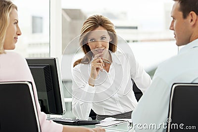 Financial advisor with couple at meeting in office - lawyer providing advice to man and woman - real estate agent with clients Stock Photo