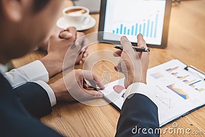 Financial advisory services. Asian advisor showing plan of investment to clients in the consultancy office Stock Photo