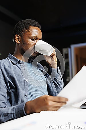 Financial analyst evaluates revenue balance on files Stock Photo