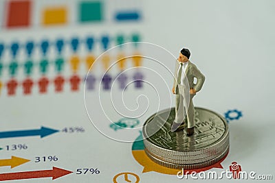 Financial business concept as miniature businessman standing on Stock Photo