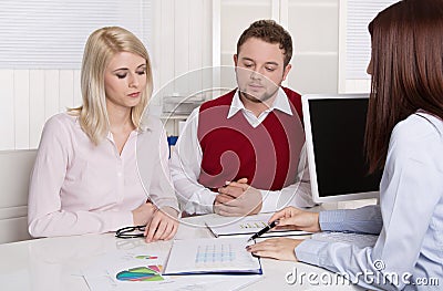 Financial business meeting: young married couple - adviser and c Stock Photo