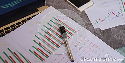 financial chart diagram in white paper with the pen and laptop Stock Photo