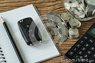 Financial concept as car key with stack of coin, pencil note boo Stock Photo