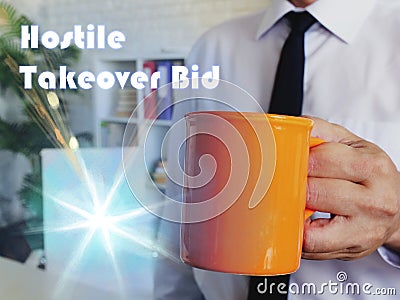 Financial concept about Hostile Takeover Bid Man with a cup of coffee in the background Stock Photo