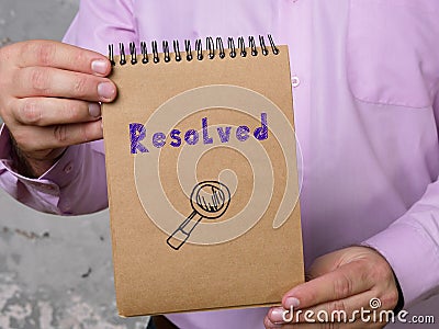 Financial concept meaning Resolved with phrase on the piece of paper Stock Photo