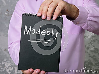 Financial concept about Modesty with sign on the piece of paper Stock Photo