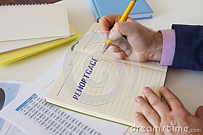 Financial concept about REMORTGAGE with sign on the laptop Stock Photo