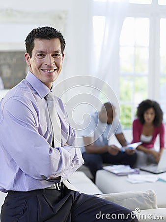 Financial Consultant With Couple In Background Stock Photo