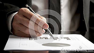 Financial consultant reviewing statistical graphs and charts Stock Photo