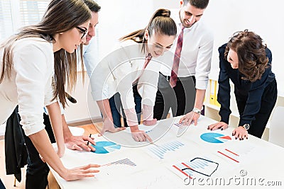 Financial consultants in bank analyzing data Stock Photo