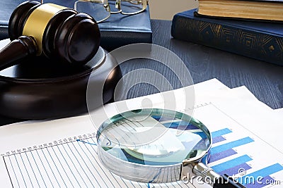 Financial crime. Gavel and Magnifying glass with business documents. Fraud. Stock Photo