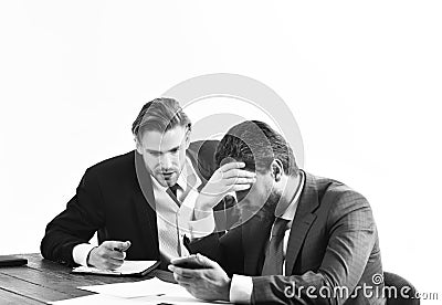 Financial crisis, credit debt, bankruptcy. Men in with tired, worried faces read business news. Business partners in Stock Photo