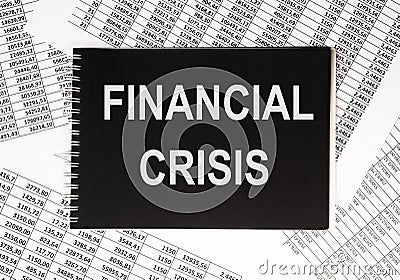 Financial crisis inscription on black paper among financial documents Stock Photo