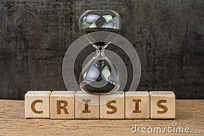 Financial crisis, investment or economic bubble burst countdown concept, sandglass or hourglass on wooden cube block with alphabet Stock Photo