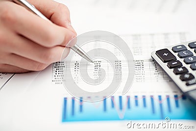 Financial data analyzing. Counting on calculator. Stock Photo