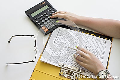 Financial data analyzing. Counting on calculator. Hand with pen Stock Photo