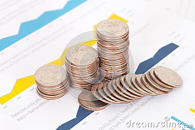 Financial documents on a pile of dollar coins Stock Photo