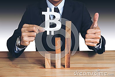 Financial growth concept, Businessman holding showing bitcoin symbol, concede Rise of price and the continued growth Stock Photo
