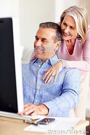 Financial, hug or mature couple with computer in home for retirement savings or pension budget. Planning, finance news Stock Photo