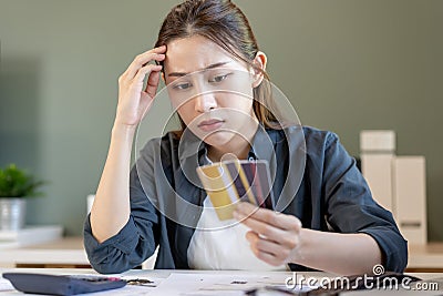 Financial owe, hand of asian woman sitting, holding many credit card, stressed by calculate expense from invoice or bill, no Stock Photo