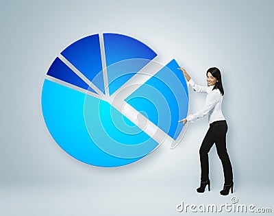 Financial report & statistics. Girl put sector of pie chart. Stock Photo