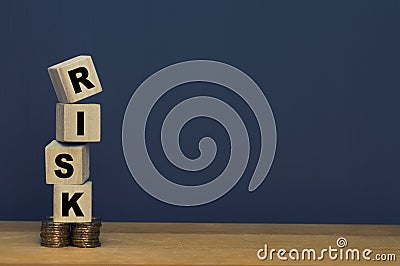 Financial risk management concept. Wooden block stacked on gold coins and copy space Stock Photo