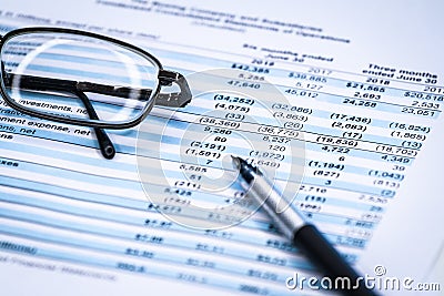 Financial statement and eyeglass, business concept, document is mock-up Stock Photo