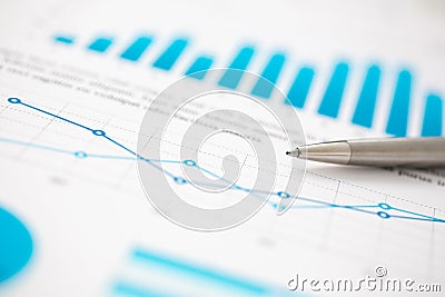 Financial statistics documents ball pen infographics at office table Stock Photo